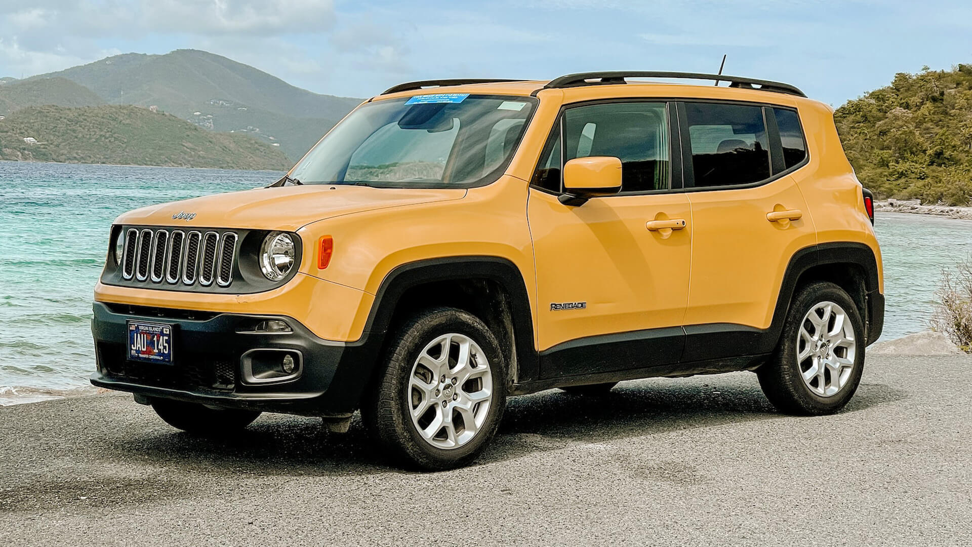 Compact SUV beside a scenic coastal route